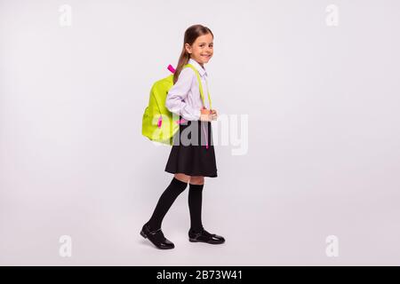 Full length body size profile side view portrait of her she nice attractive cheerful cheery pre-teen girl going walking back to school isolated over Stock Photo