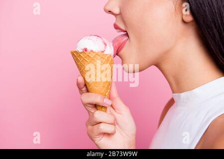 Close-up profile side view portrait of her she nice-looking lovely attractive cheerful cheery glad lady licking favorite ice cream berry taste flavor Stock Photo