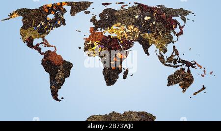 Map of world from different kind of dry tea herbs on blue background. Stock Photo