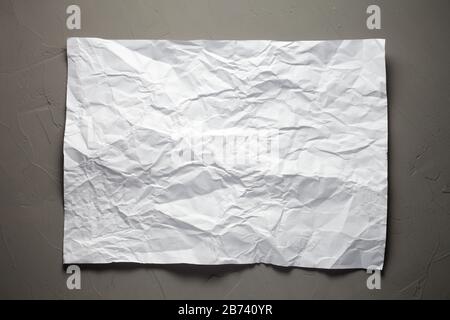 Sheet of white crumpled paper on concrete background Stock Photo