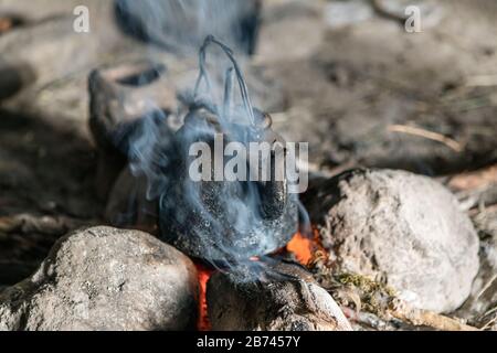 coffee pot boiling over an open fire cowboy flame smoke caffine wild west  Stock Photo - Alamy