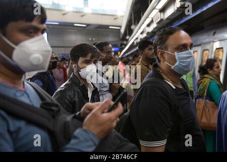 New Delhi, India. 13th Mar, 2020. People wearing masks wait at a metro station in New Delhi, India, March 13, 2020. The number of the COVID-19 cases in India Friday rose to 81, India's federal health ministry officials said. Credit: Javed Dar/Xinhua/Alamy Live News Stock Photo