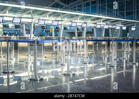 Empty check-in desks at the airport terminal. Stock Photo