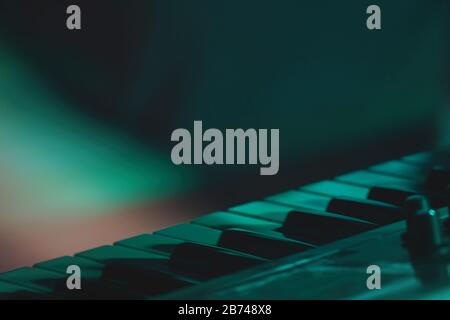 Part of the keyboard of a synthesizer standing on the stage during a performance. Selective focus Stock Photo