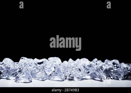 Pieces of crushed ice cubes on black background. Stock Photo
