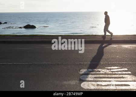 Senior man walking on seaside Stock Photo