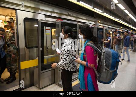 New Delhi, India. 13th Mar, 2020. People wearing masks are seen at a metro station in New Delhi, India, March 13, 2020. The number of the COVID-19 cases in India Friday rose to 81, India's federal health ministry officials said. Credit: Javed Dar/Xinhua/Alamy Live News Stock Photo