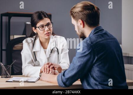 Sympathetic Female Doctor Cheering Her Patient Up Stock Photo