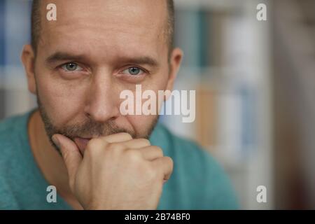Portrait of handsome mature man looking at camera with pensive sight Stock Photo