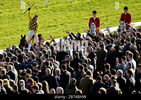 Jockey Paul Townend celebrates on Al Boum Photo after winning the Magners Cheltenham Gold Cup Chase during day four of the Cheltenham Festival at Cheltenham Racecourse. Stock Photo