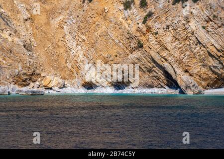 Natural beauty of rocky formation and isolated beaches in Mediterranean islands in Greece - Seascape background scenery with deep blue sea.