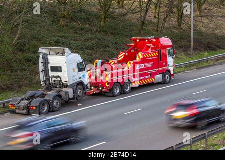 Chorley, Lancashire, UK.  13th March, 2020. Multiple HGV breakdowns on the M6 Motorway lane.  As the efficacy of smart motorways is challenged after 38 deaths in five years after collisions on the hard shoulder. Two HGVS breakdown within 50 yards of each other in Lancashire making for a difficult recovery for Hough Green 24 Hour breakdown rescue service team. Stock Photo