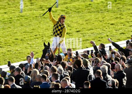 Jockey Paul Townend celebrates on Al Boum Photo after winning the Magners Cheltenham Gold Cup Chase during day four of the Cheltenham Festival at Cheltenham Racecourse. Stock Photo