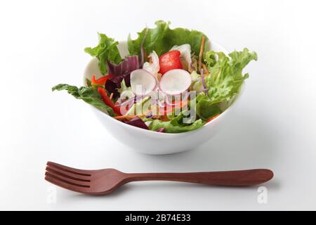 fresh green salad in bowl closeup isolated on white background Stock Photo
