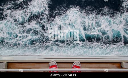 Crossing the Atlantic Ocean from Brooklyn to Southampton onboard the ocean liner Queen Mary 2. Rough sea foaming along the side of the QM 2. Stock Photo