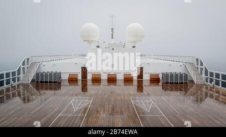 Crossing the Atlantic Ocean from Brooklyn to Southampton onboard the ocean liner Queen Mary 2. Markups for shuffleboard seen on the top deck of the QM 2. Stock Photo