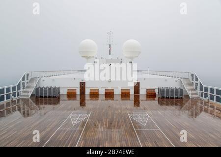 Crossing the Atlantic Ocean from Brooklyn to Southampton onboard the ocean liner Queen Mary 2. Markups for shuffleboard seen on the top deck of the QM 2. Stock Photo