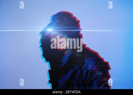 Man in hood and cyber glasses. Game character. Concept of virtual reality, cyber games and science fiction. Image with glitch effect. Stock Photo