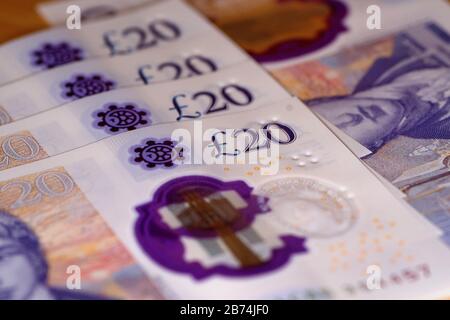 uk twenty pound notes trapped in mousetrap Stock Photo