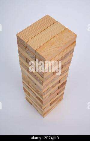 A game with wooden bricks where you have to remove them without knocking it over Stock Photo