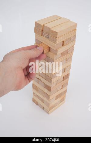 A game with wooden bricks where you have to remove them without knocking it over Stock Photo