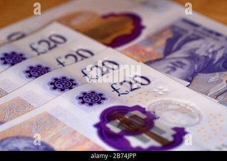 uk twenty pound notes trapped in mousetrap Stock Photo