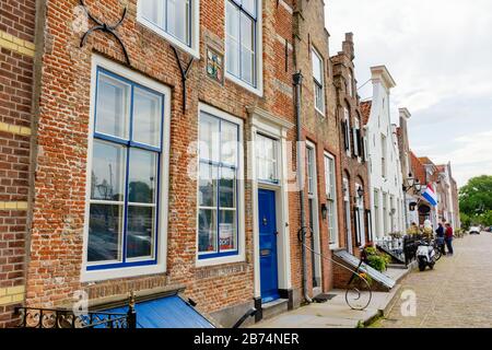 Veere, Netherlands - June 09, 2019: historic buildings in Veere, with unidentified people. Veere is famous for its picturesque old town and a popular Stock Photo