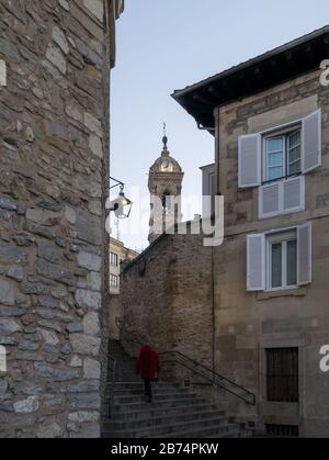 Woman walking up a stairway in the old town of Vitoria-Gasteiz, Basque Country, Spain, early in the morning at sunrise Stock Photo