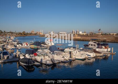 Marina in Los Cerritos Wetlands with oil refineries in the distance, Long Beach, california, USA Stock Photo