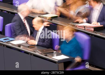 During a debate in the Bundestag, Chancellor Angela Merkel, CDU, right, Finance Minister Olaf Scholz, SPD, centre and Interior Minister Horst Seehofer appear blurred and blurred on the government bench. The photo was taken by long time exposure. [automated translation] Stock Photo