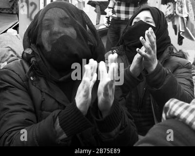 Refugee camp in Idomeni on the border with Macedonia. Women during a sit-in on the railroad tracks at camp. [automated translation] Stock Photo