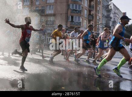 Participants in the 43rd Berlin Marathon in the Schoeneberg district of Berlin will be cooled off with a water shower. 41,283 runners participated in the marathon. [automated translation] Stock Photo