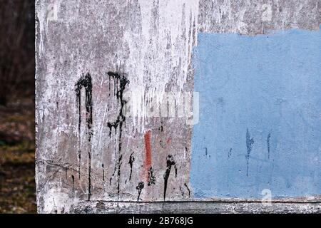 number 13 painted on dirty concrete wall on the corner of old abandoned house Stock Photo
