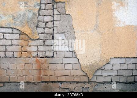 ruined brick wall with stucco and rust Stock Photo