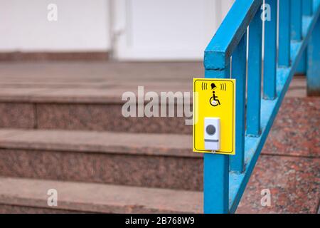 Bell button for disabled customers near the pharmacy stairs to call staff Stock Photo