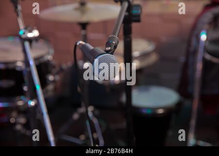 Musical Concept. recording, selective focus microphone in radio studio, selective focus microphone and blur musical equipment guitar,bass,drum piano Stock Photo