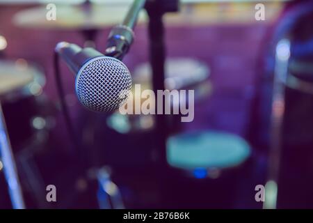 Musical Concept. recording, selective focus microphone in radio studio, selective focus microphone and blur musical equipment guitar,bass,drum piano Stock Photo