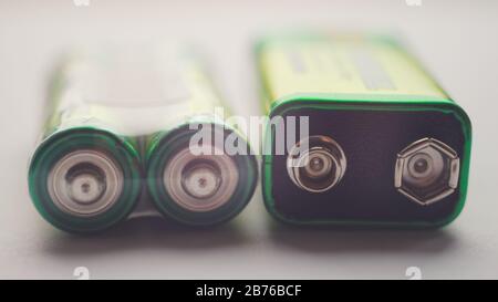Two different types of batteries on the table close-up Stock Photo