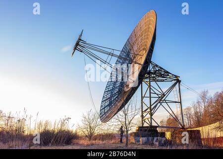 man stands near a large radio telescope research satellite Stock Photo