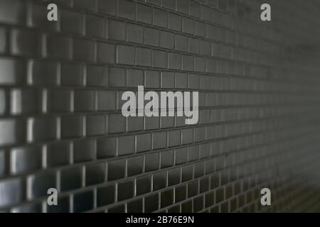 Metal mosaic background with a moving perspective of small bricks. Stock Photo