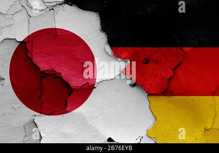 flags of Japan and Germany painted on cracked wall Stock Photo