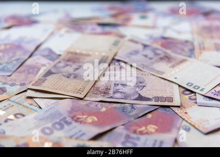 Argentinian one hundred pesos bill money scattered on a table Stock Photo