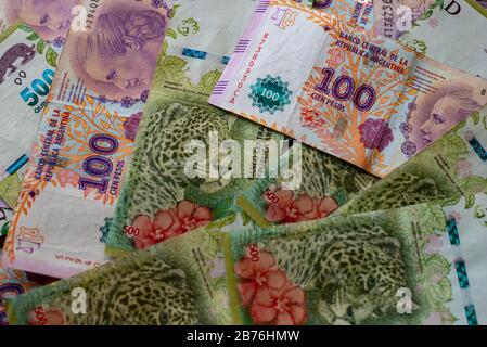 Argentinian one hundred pesos and five hundred pesos bill money scattered on a table Stock Photo