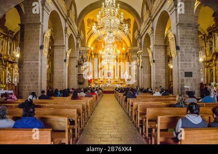 Cusco, Peru; January 22, 2017: Inside of La Merced Convent with chandeliers, pulpit and altar in Cusco, Peru Stock Photo