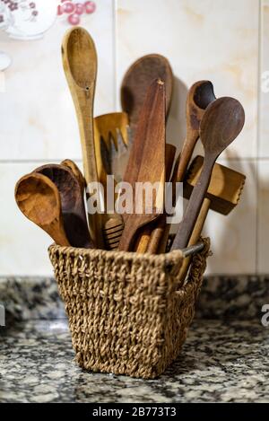 Bunch of wooden cutlery set on a wicker bowl Stock Photo