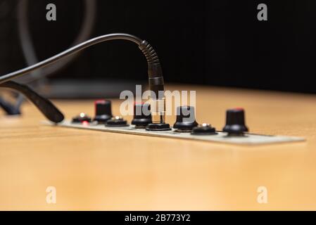 Close up of an audio jack from a headphone and four audio levelers on a radio studio Stock Photo