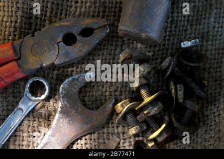 old hand tool, craftsman tool, top view hand tool with nut, wrench and pliers (selective focus) Stock Photo