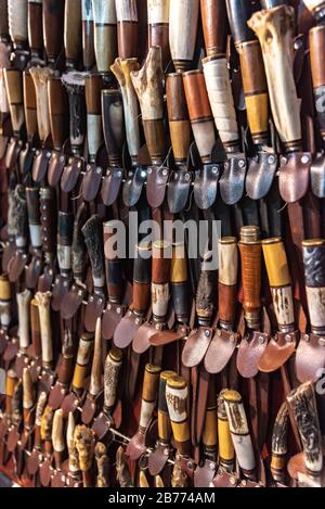 Lots of handmade blades inside their leather scabbards Stock Photo