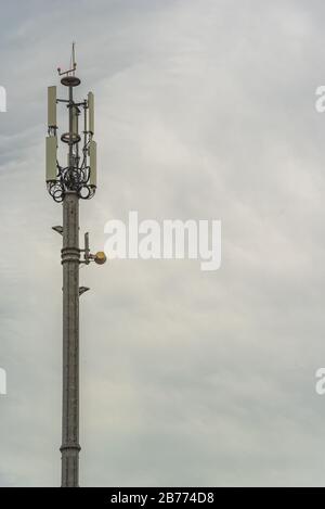 Network antenna on a gray cloudy day Stock Photo