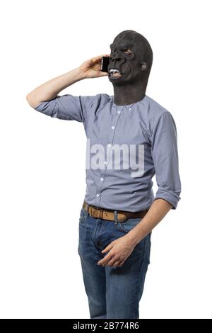 Vertical shot of a male in a black angry mask talking on a phone Stock Photo